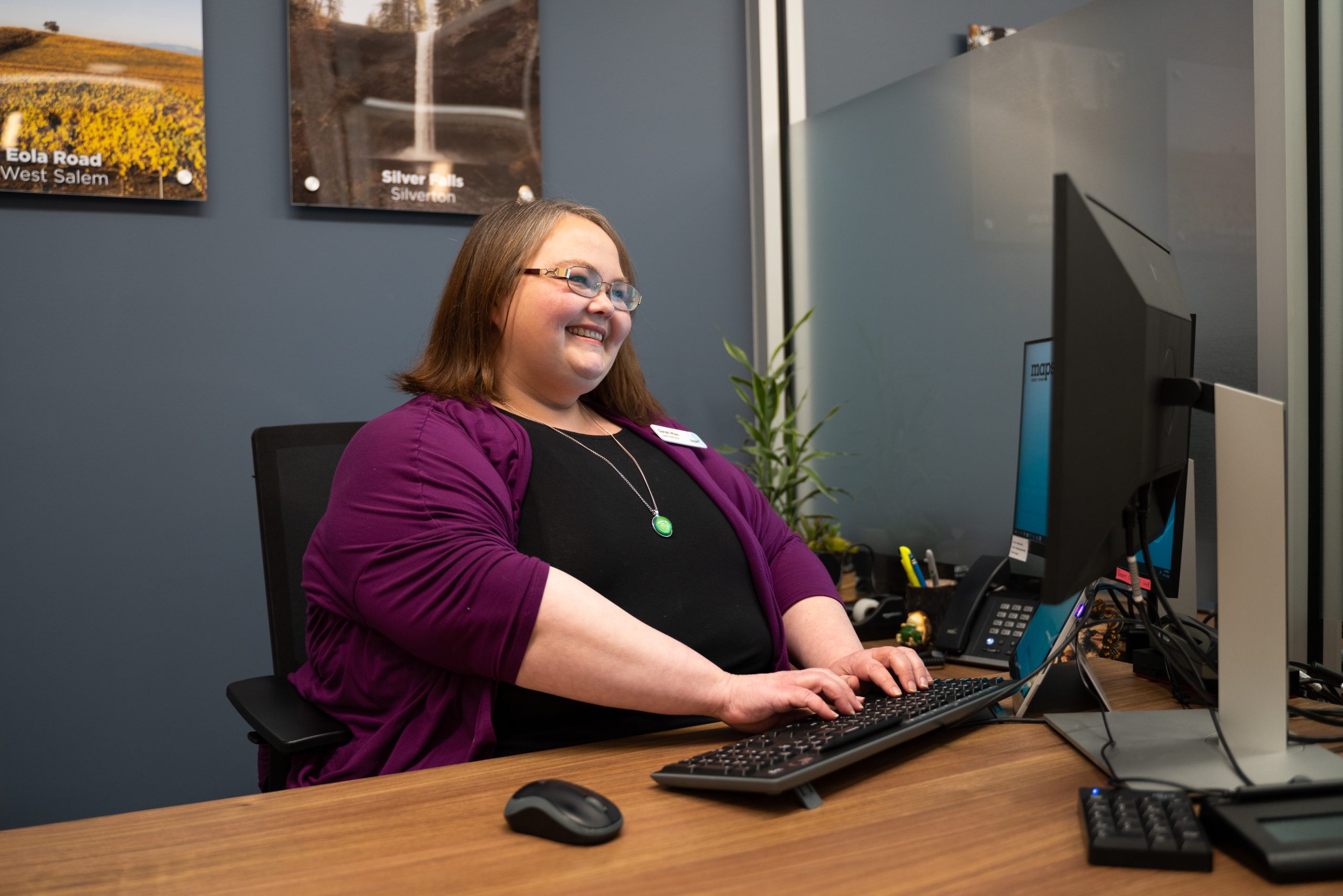 Woman smiling, working at computer
