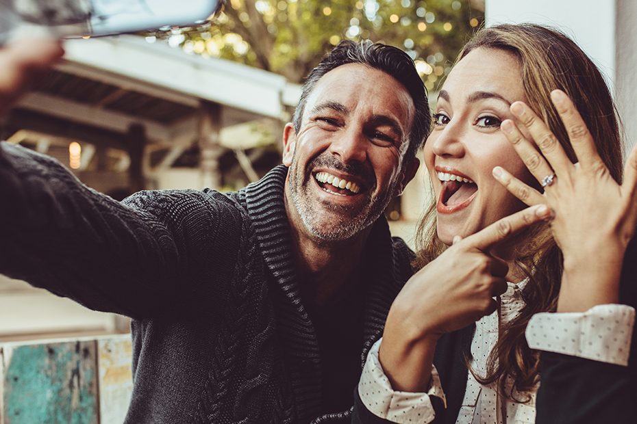 Beautiful engaged couple making selfie